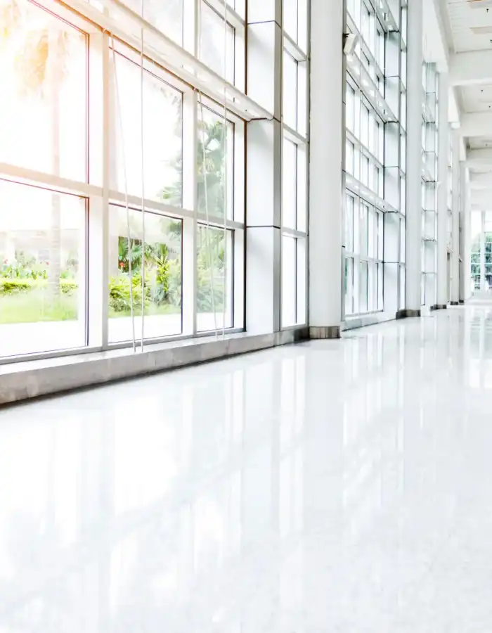 dc2f0ff6-703e-4fa9-b4f9-0d601d362bb7 (1) A large white room with many windows and a shiny floor.