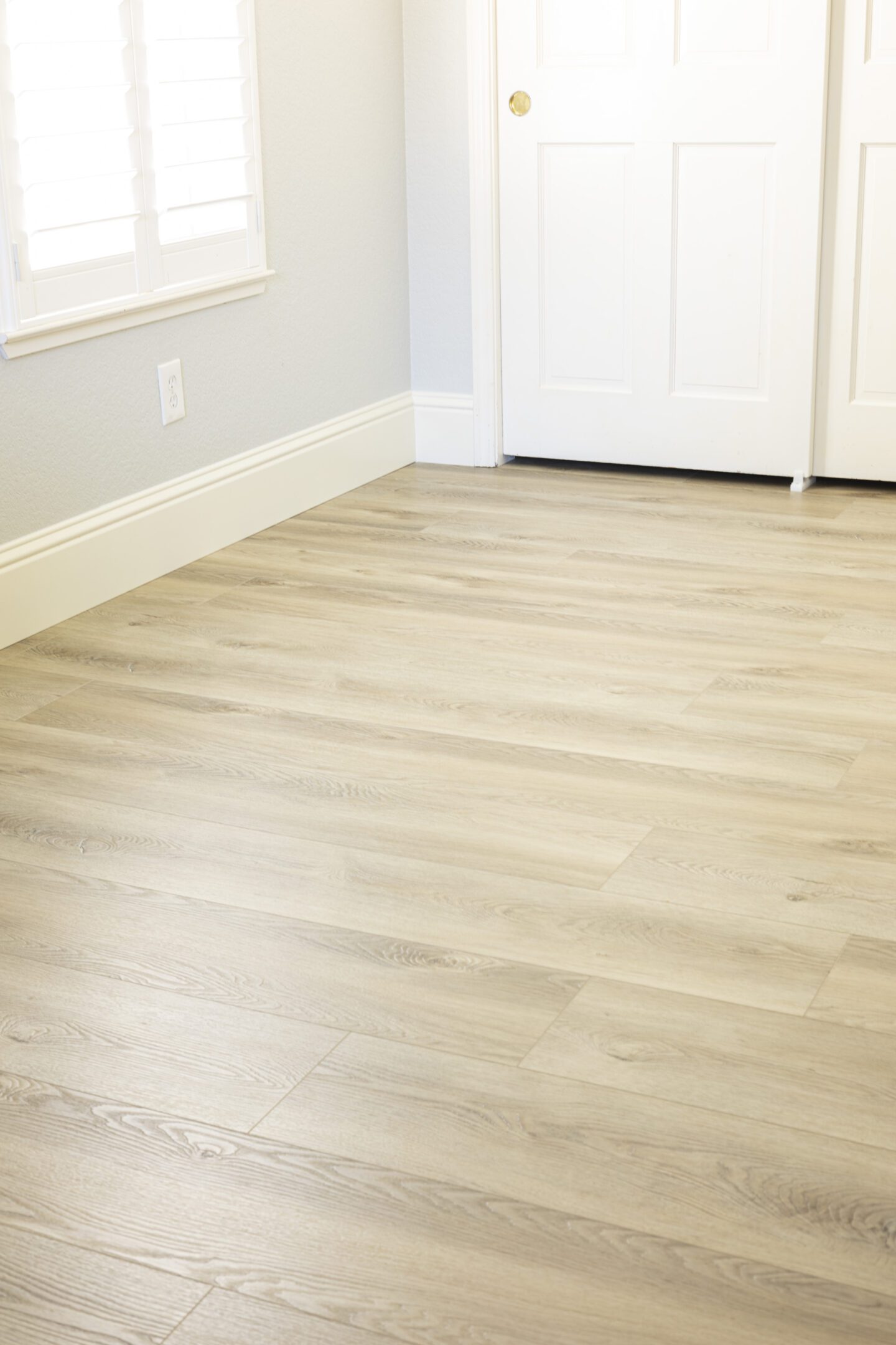 A white door and floor in a room.