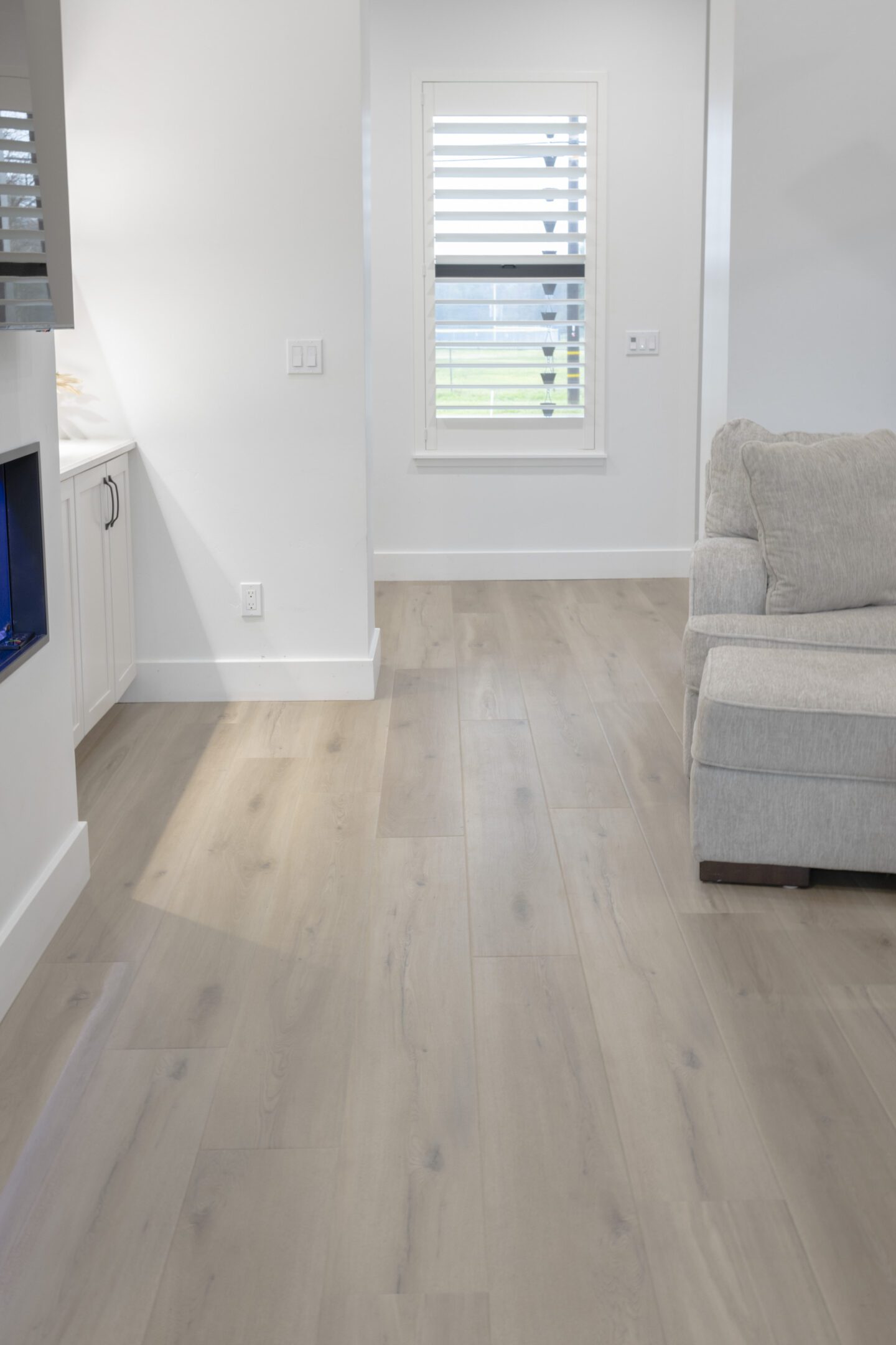 A living room with white walls and wooden floors