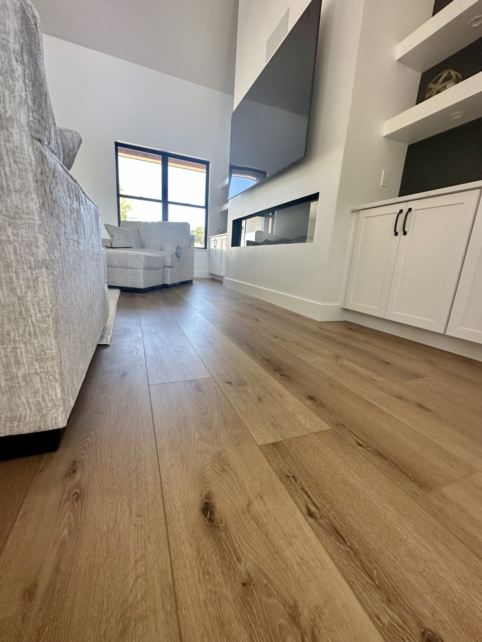 A room with hard wood floors and white walls.
