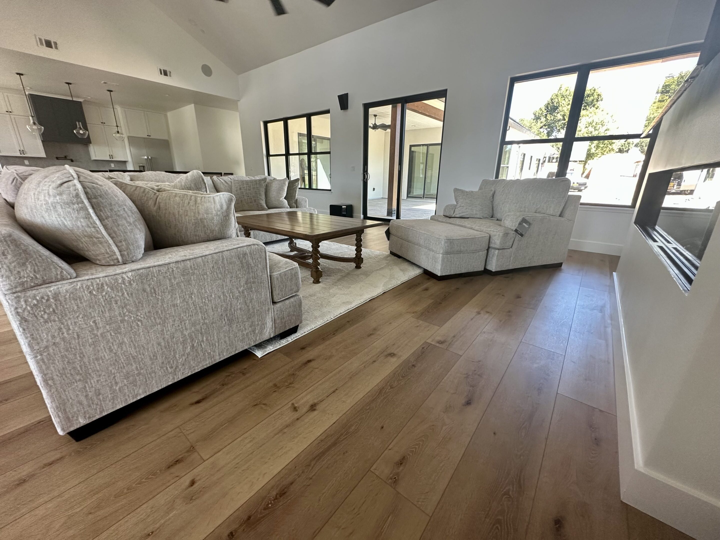 A living room with hardwood floors and white walls.