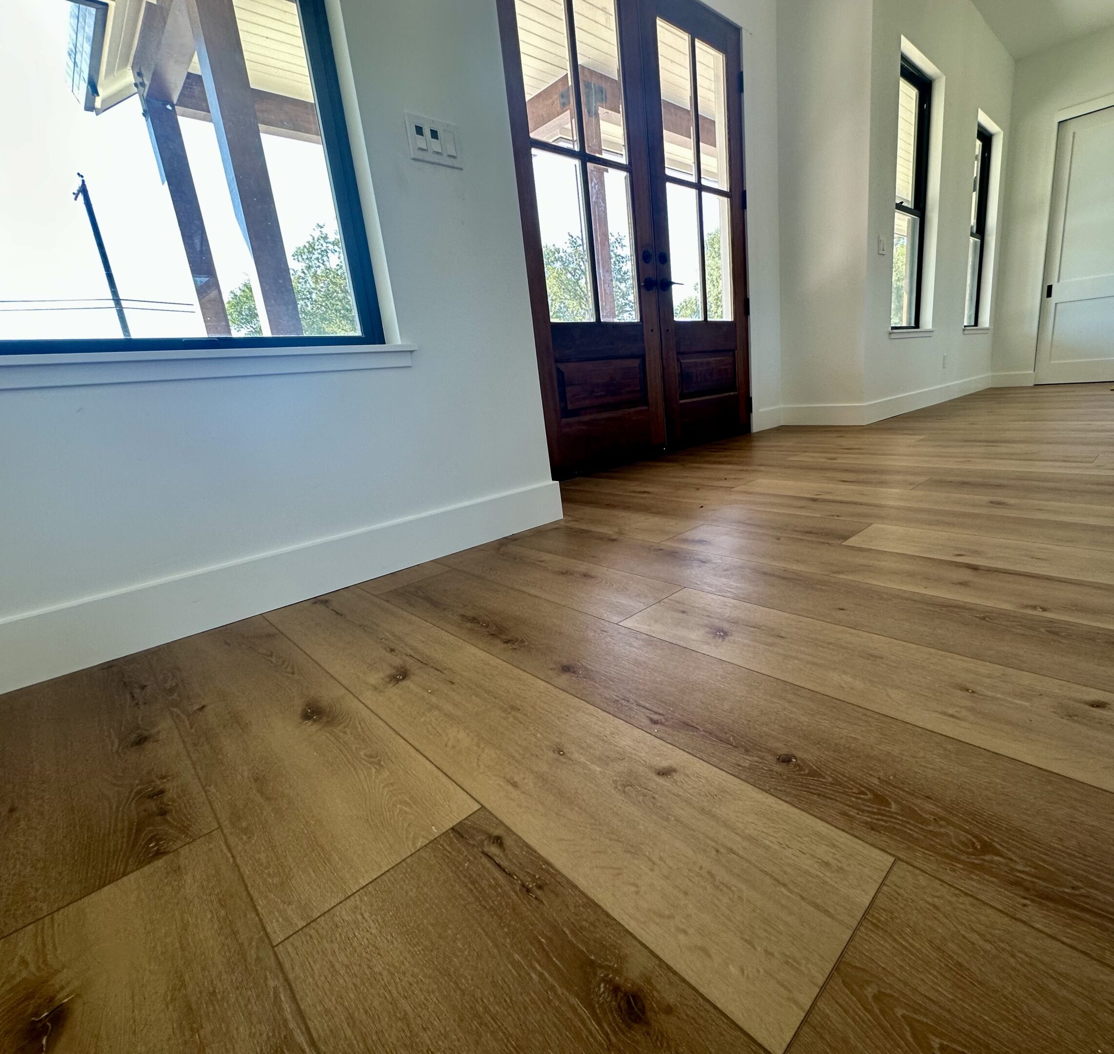 A room with wooden floors and windows.