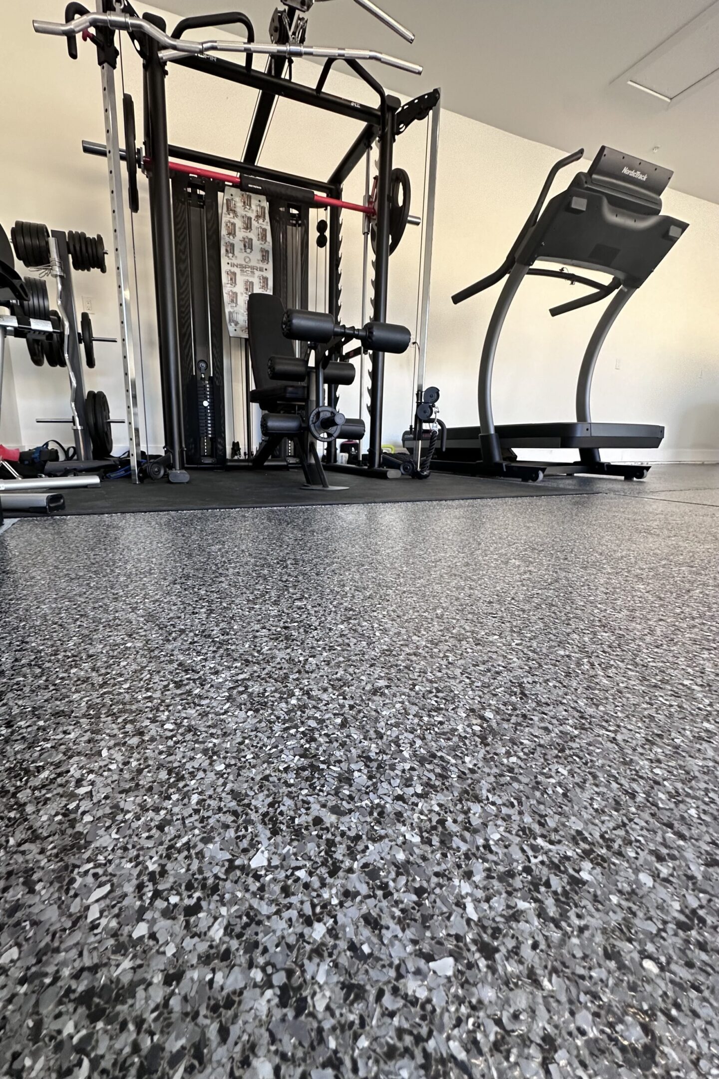 A gym with many machines and a floor.