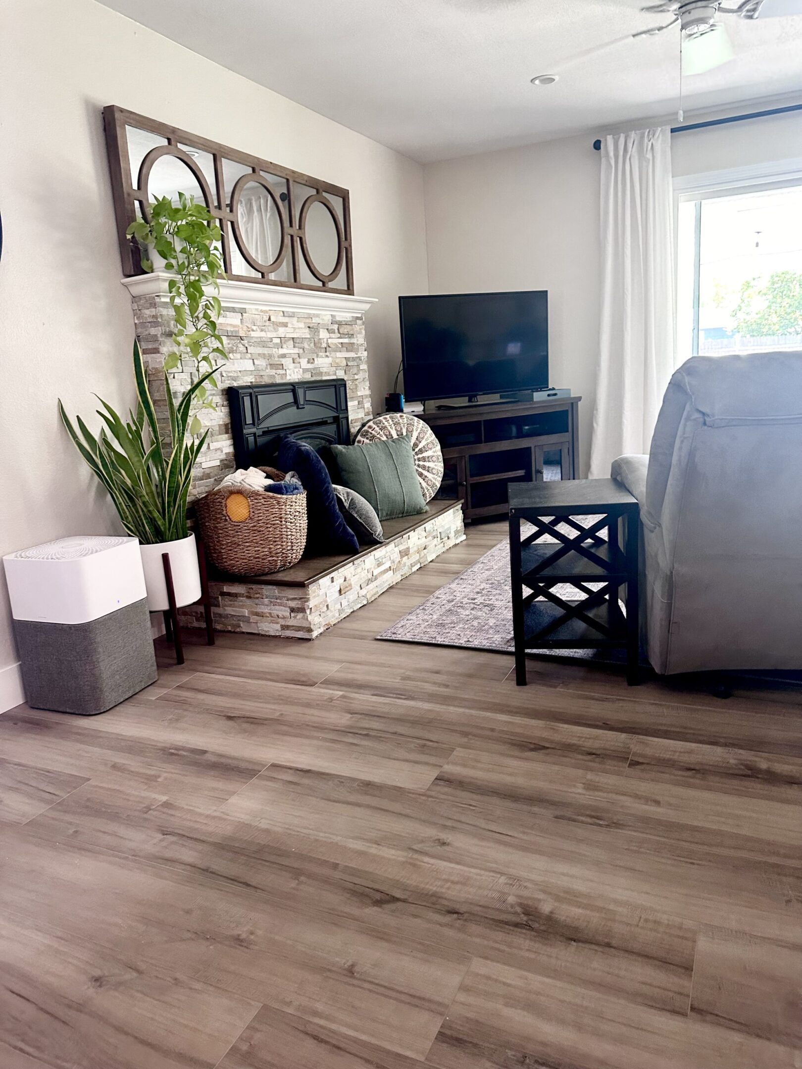 A living room with hard wood floors and a fireplace.