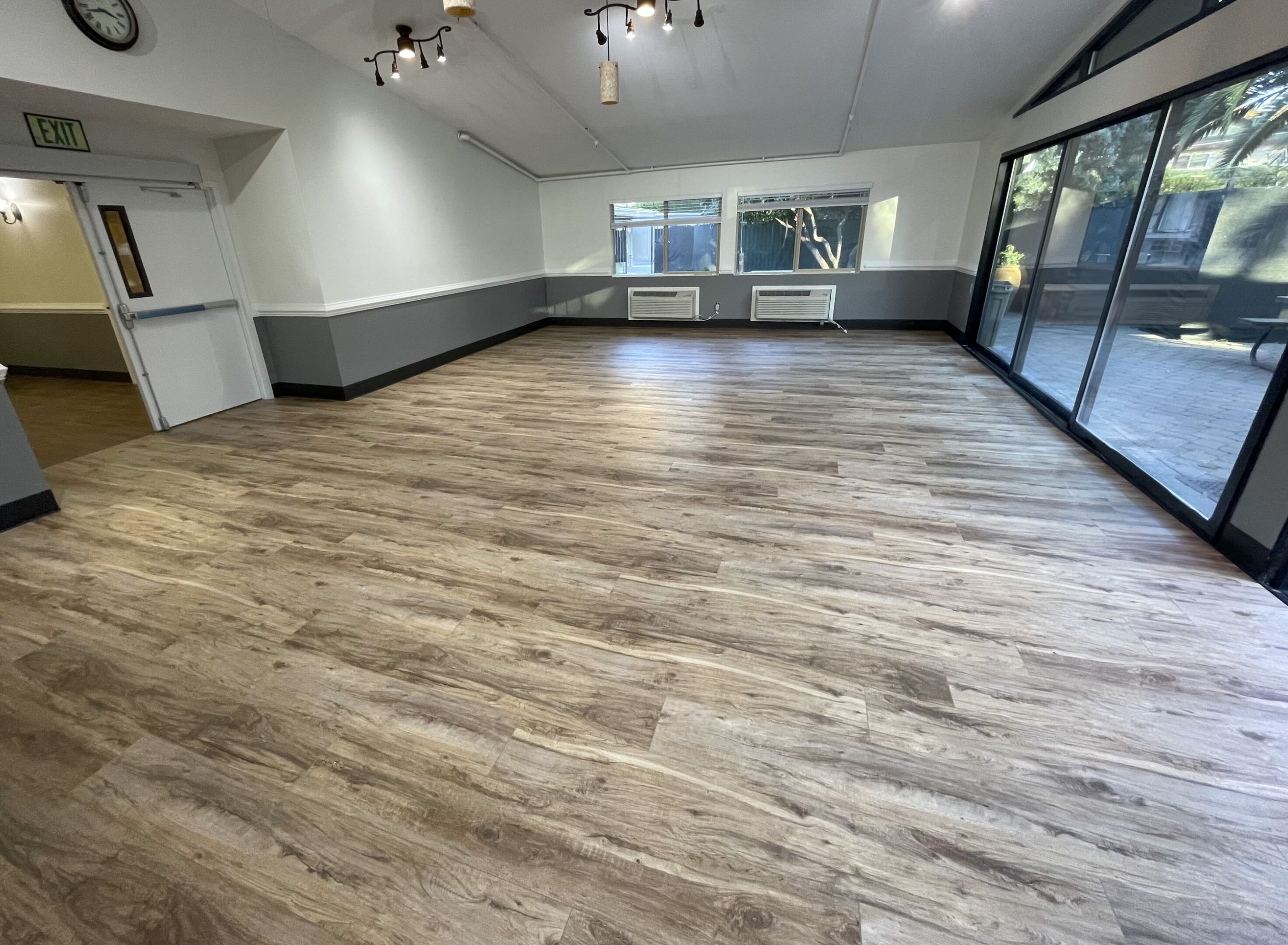 A room with wooden floors and white walls.
