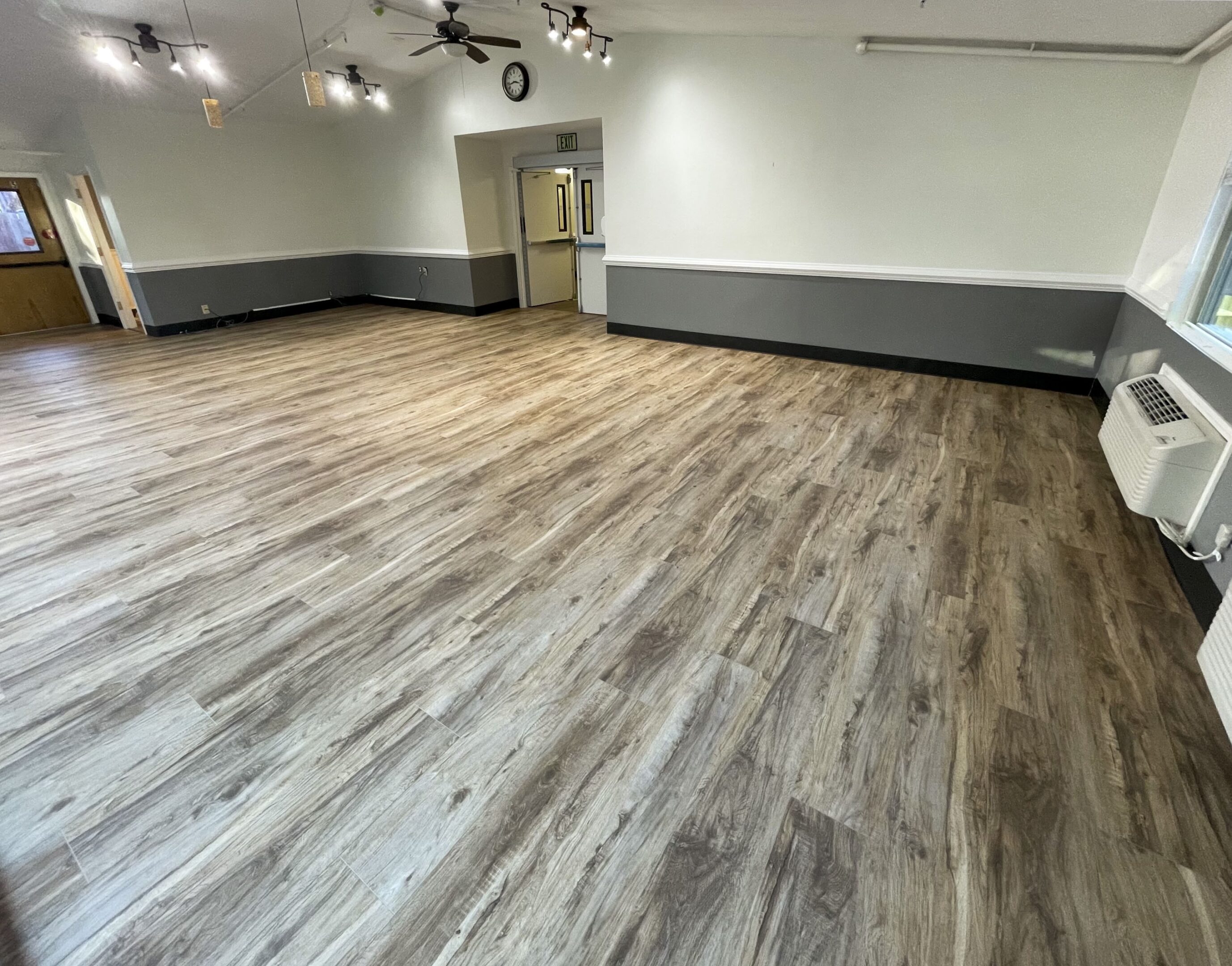 A room with wooden floors and white walls.