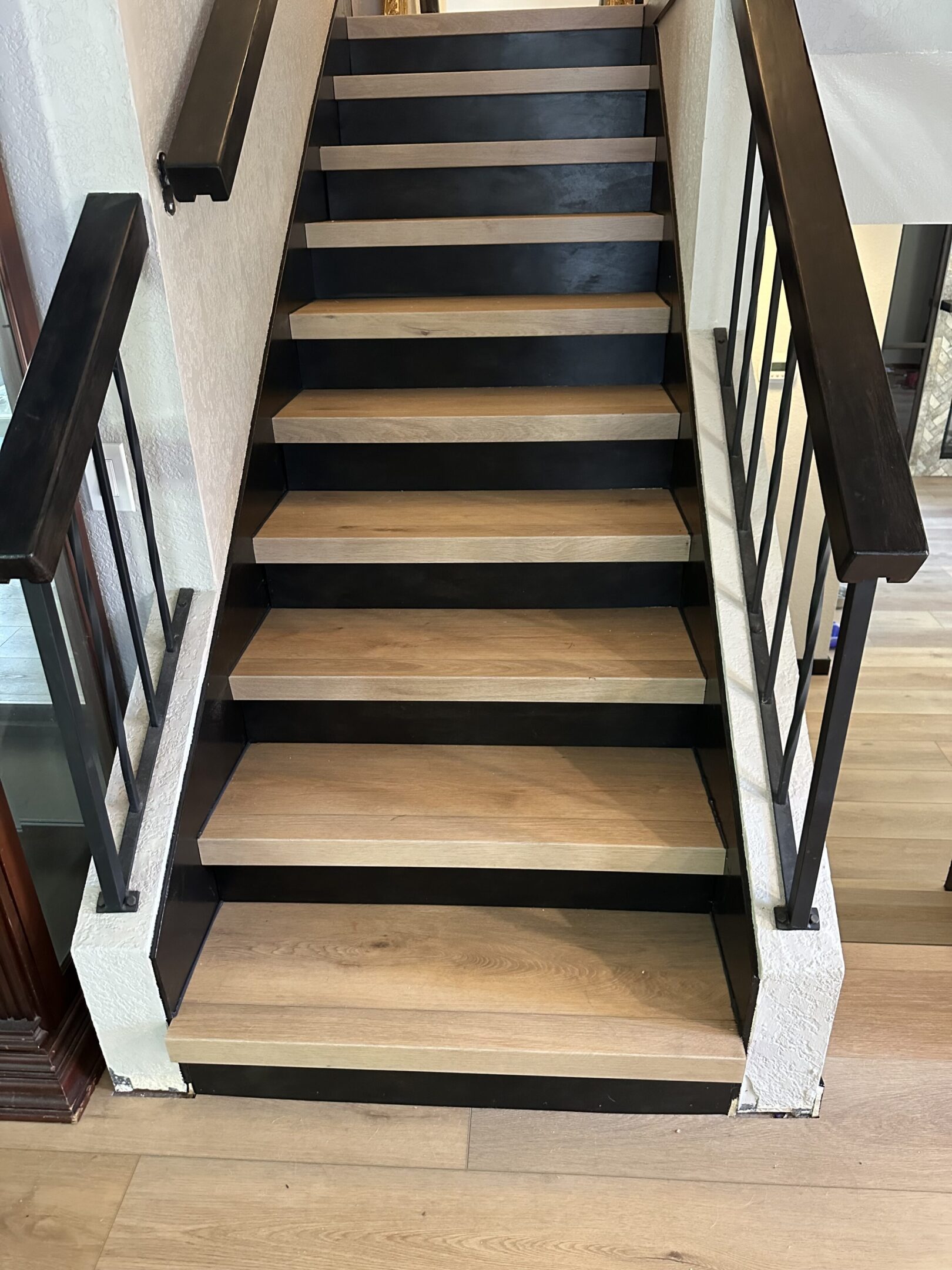 A staircase with wooden steps and metal railings.