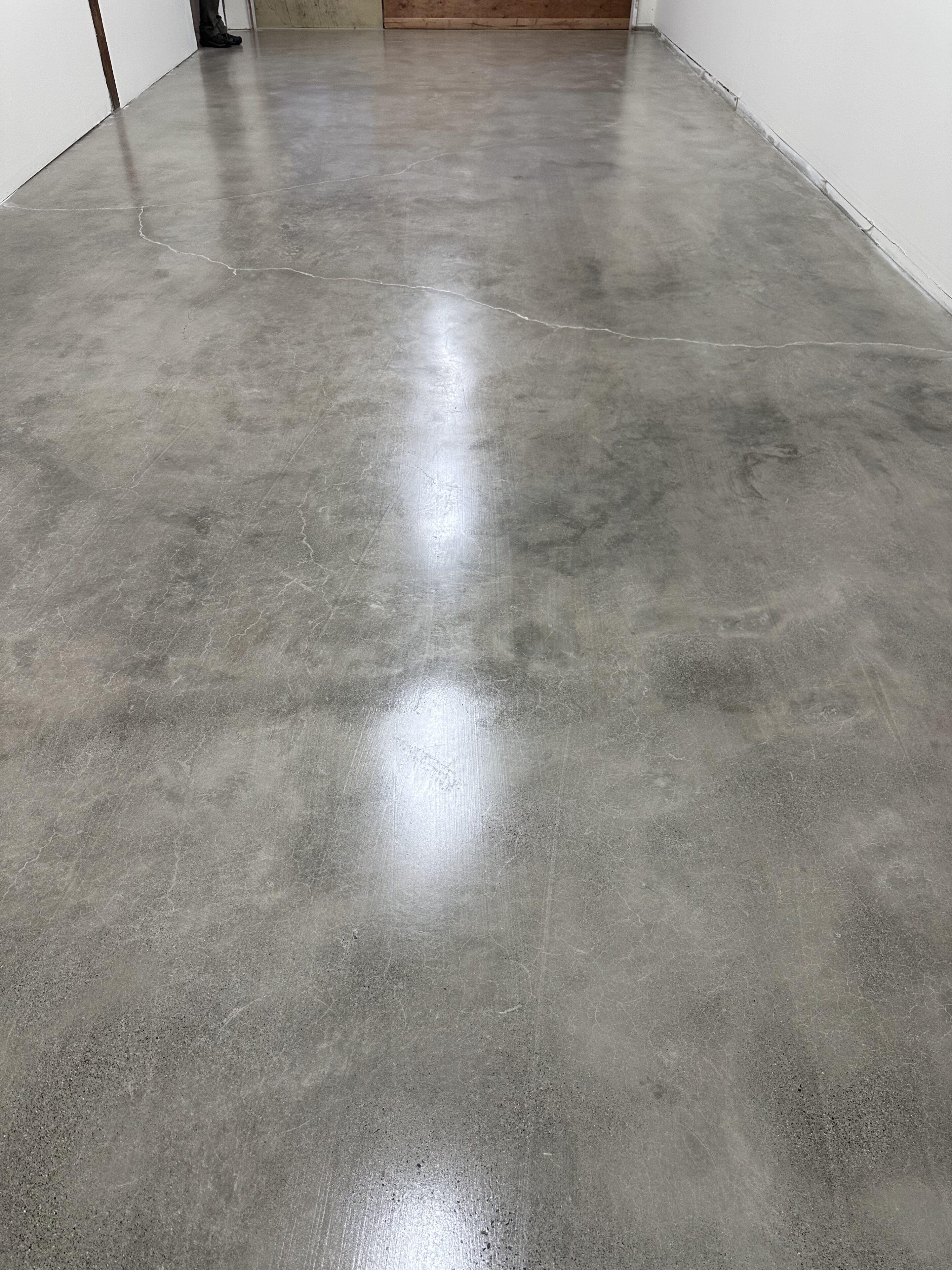 A concrete floor with a white streak of light