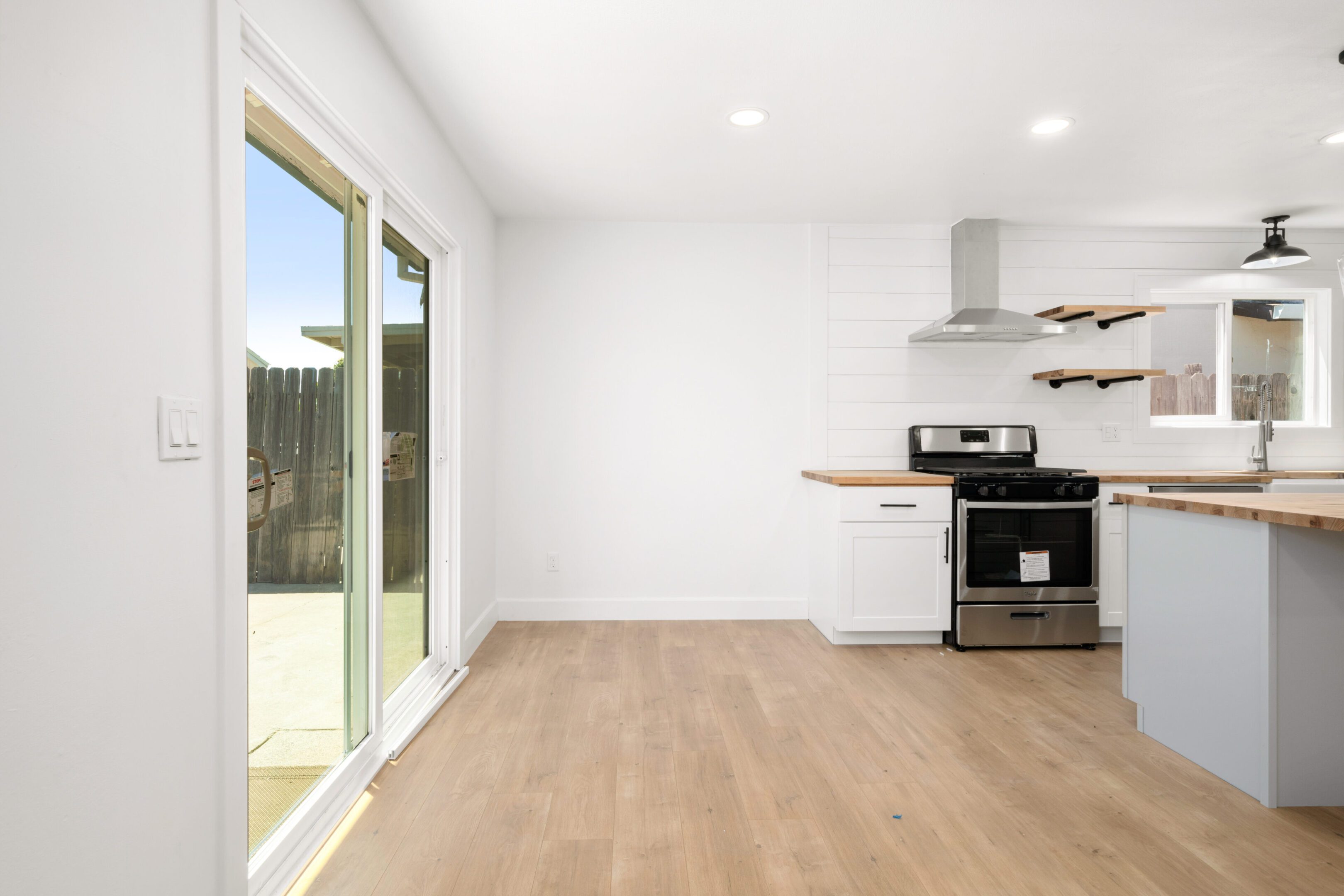 A kitchen with an oven and sliding glass doors.