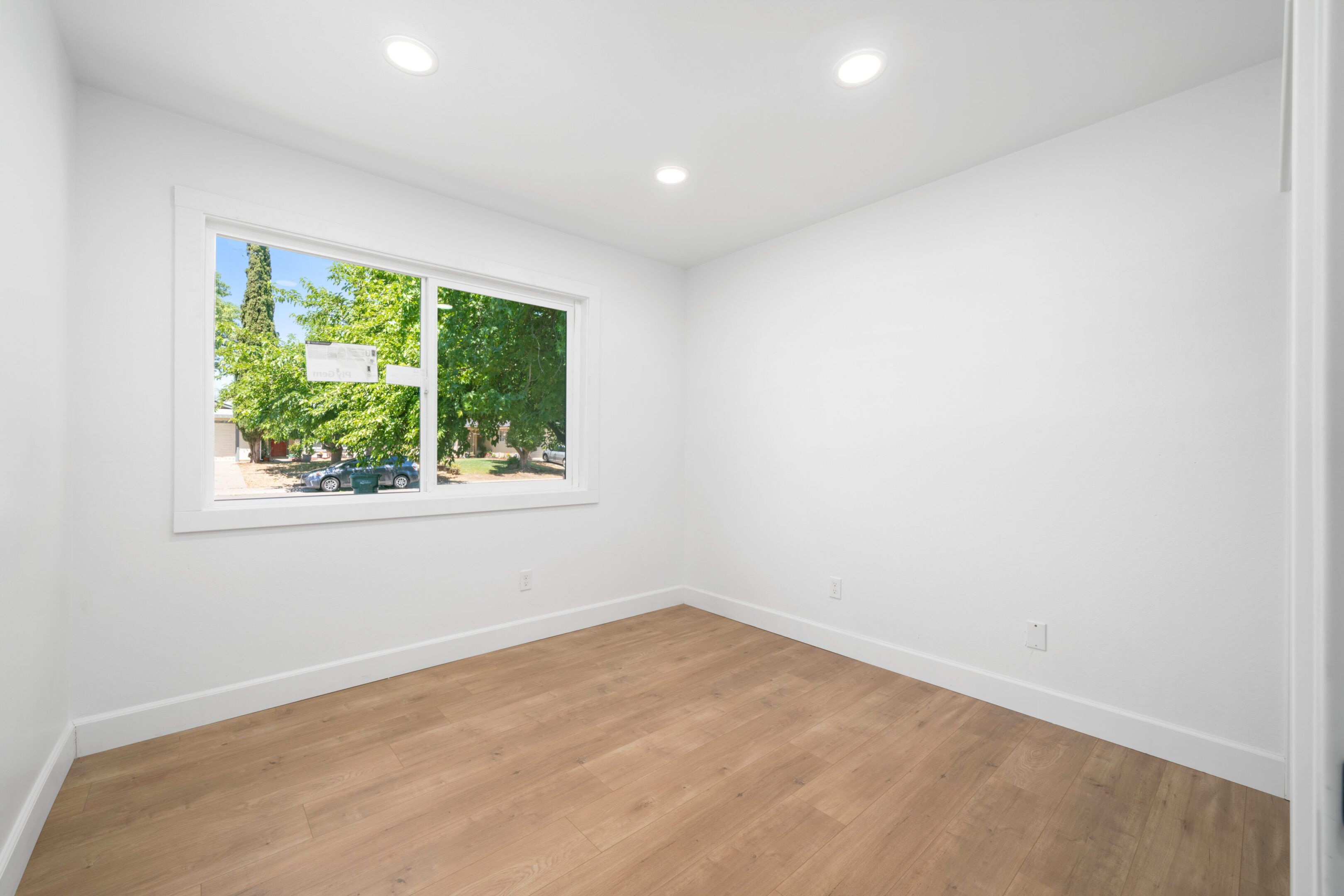A room with a window and wooden floors