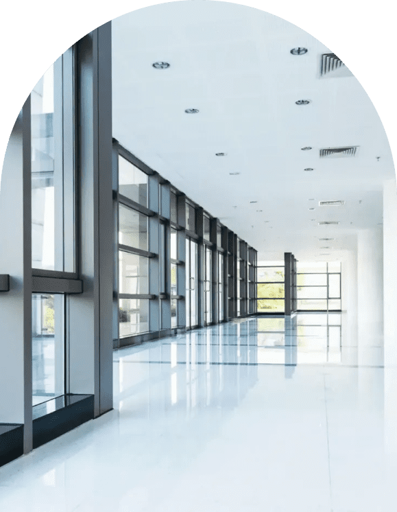 A large hallway with many windows and glass doors.